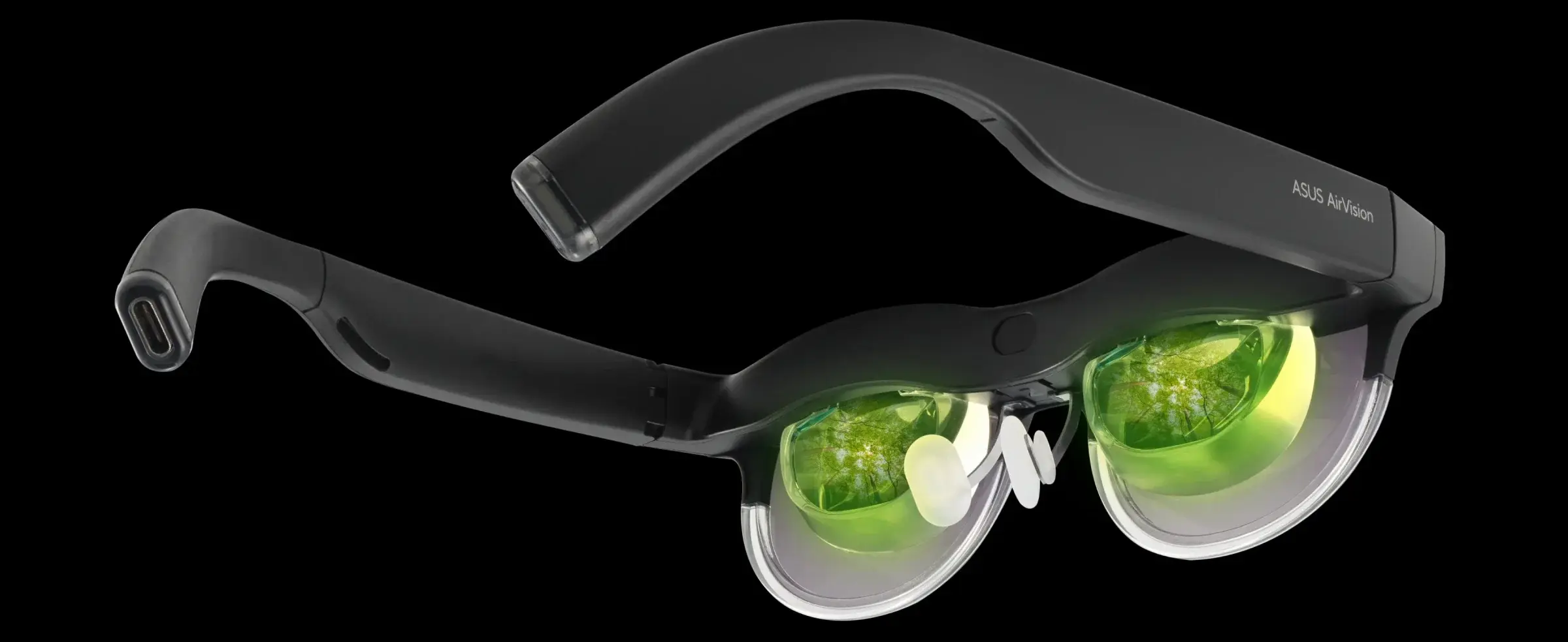 A pair of augmented reality glasses with green-tinted lenses, integrated microphones, and a sleek black frame, labeled "ASUS AirVision."