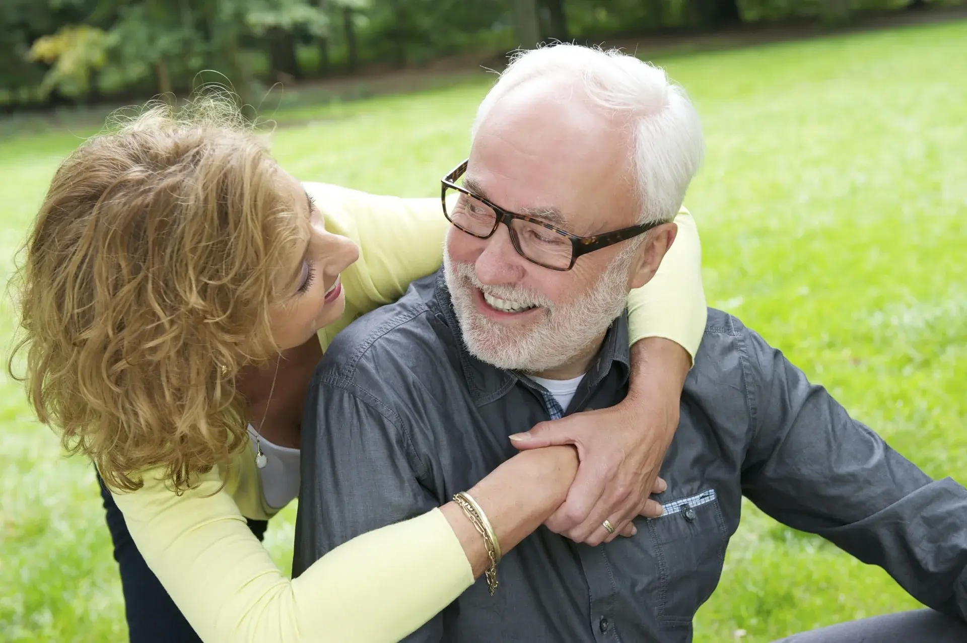 Couple embracing — invisible hearing aid scenario