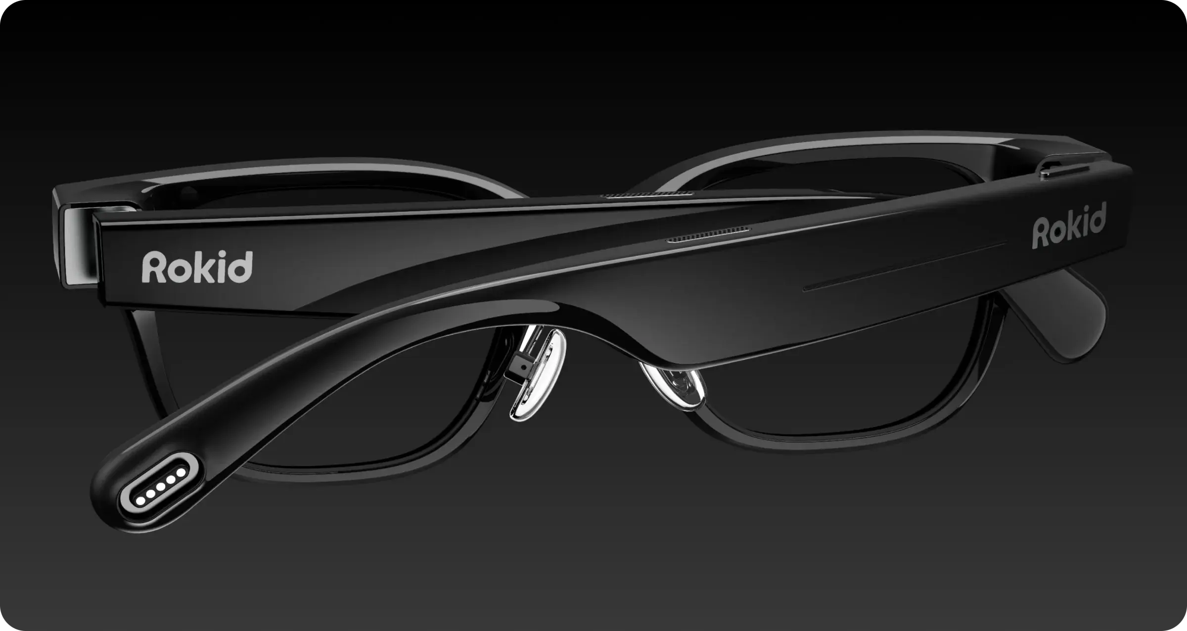 A sleek, black Rokid AR Lite augmented reality glasses with a modern design and the "Rokid" logo on the side, set against a dark background.