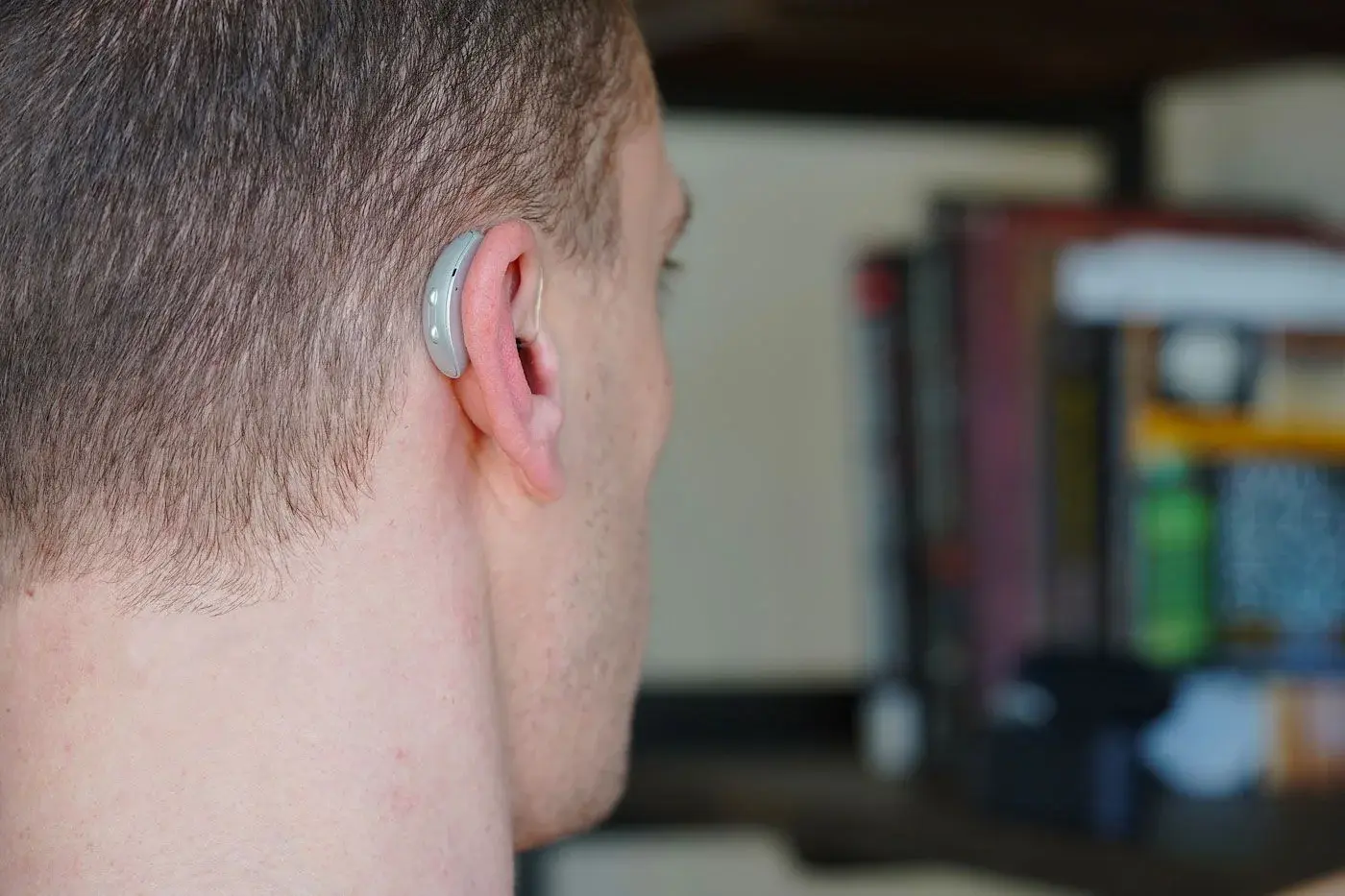 Genesis AI hearing aid worn on ear — brand context