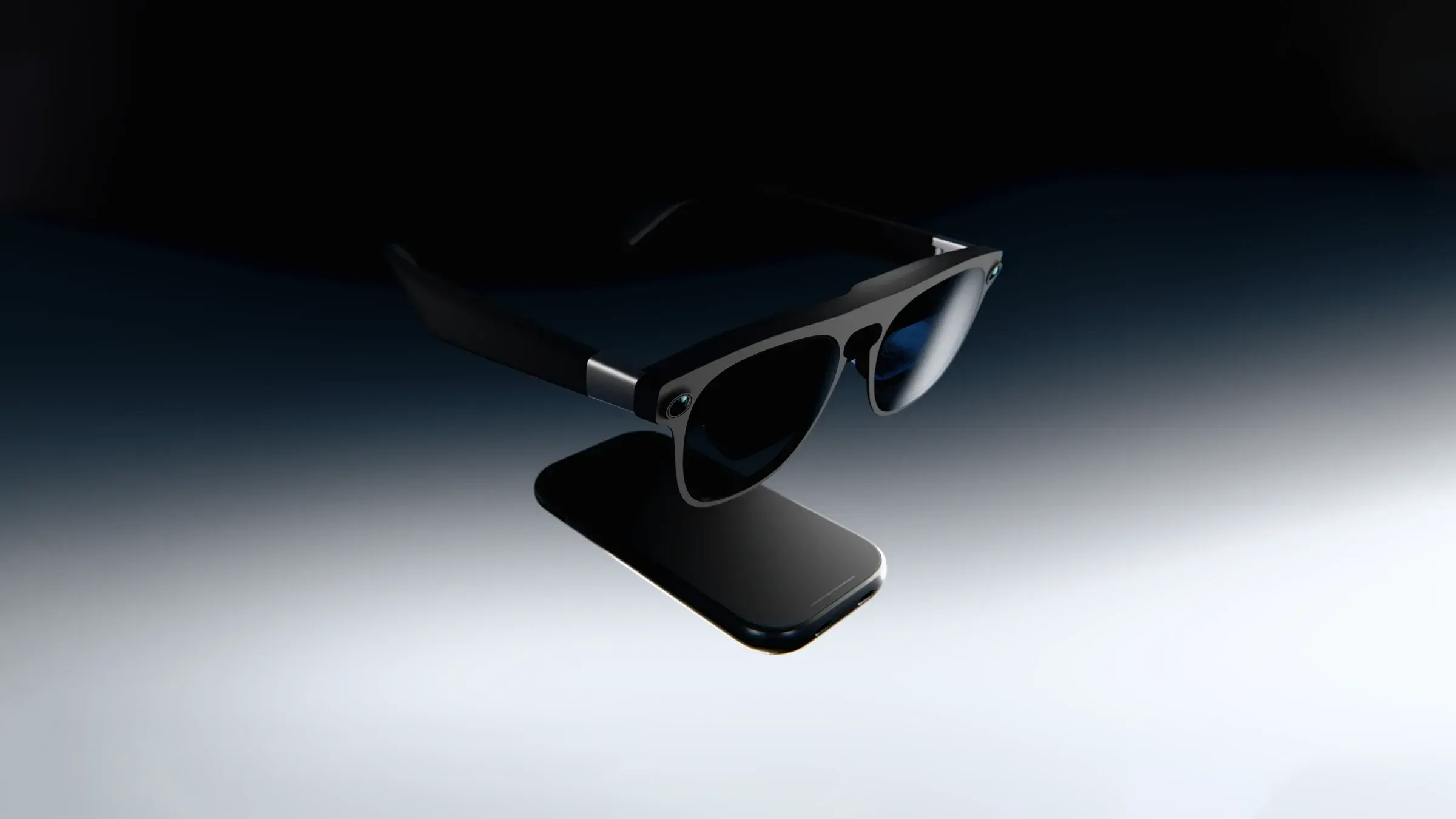 A pair of XREAL Project Aura smart glasses resting on top of a smartphone against a dark background with focused lighting.